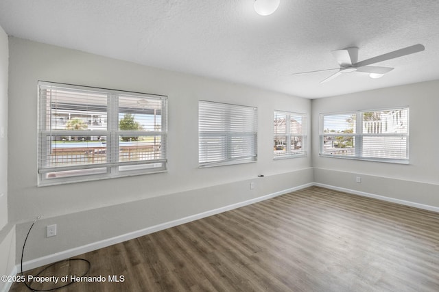 4299 Bellaire Dr, Hernando Beach, FL 34607 - spare room featuring healthy amount of natural light, wood finished floors, a textured ceiling, and ceiling fan
