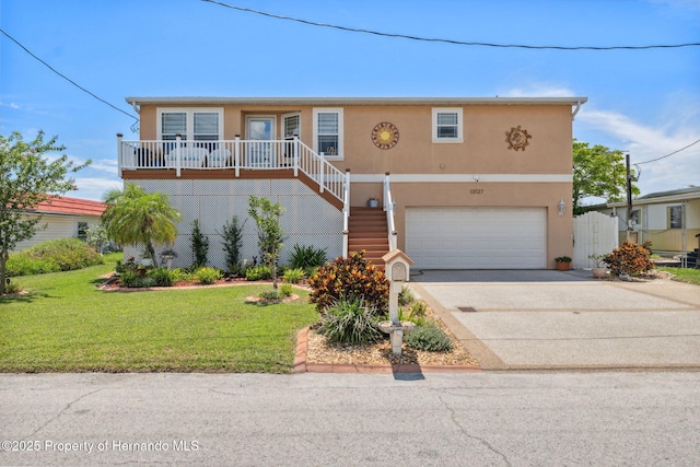 13027 Beacon Ct, Hudson, FL 34667 - view of front of property with stucco siding, a garage, a front yard, driveway, and stairway