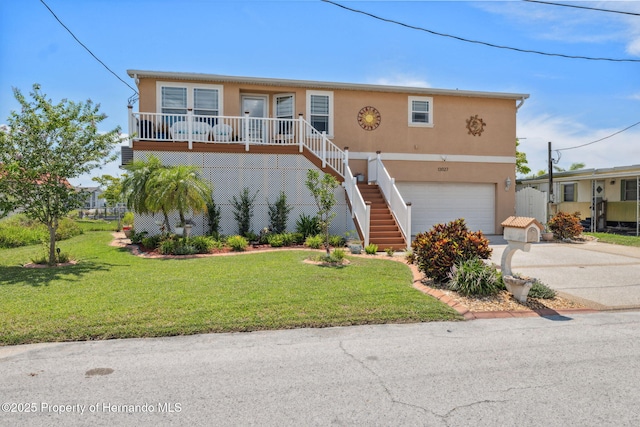 13027 Beacon Ct, Hudson, FL 34667 - view of front of property with stucco siding, an attached garage, concrete driveway, a front lawn, and stairway