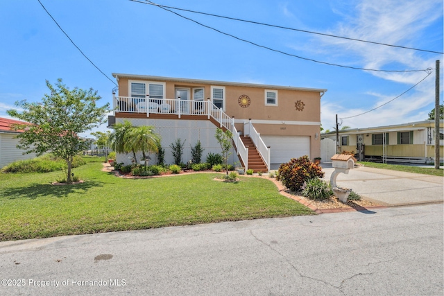 13027 Beacon Ct, Hudson, FL 34667 - view of front facade featuring driveway, stairway, stucco siding, a garage, and a front lawn