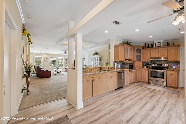 13027 Beacon Ct, Hudson, FL 34667 - kitchen with appliances with stainless steel finishes, ceiling fan, under cabinet range hood, glass insert cabinets, and open floor plan