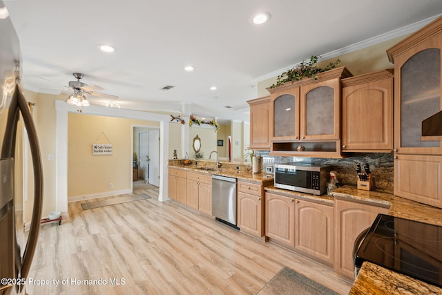 13027 Beacon Ct, Hudson, FL 34667 - kitchen with appliances with stainless steel finishes, ornamental molding, glass insert cabinets, recessed lighting, and light stone counters