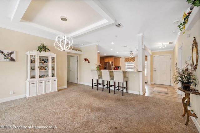 13027 Beacon Ct, Hudson, FL 34667 - kitchen with stainless steel refrigerator with ice dispenser, light carpet, a breakfast bar area, a chandelier, and a peninsula