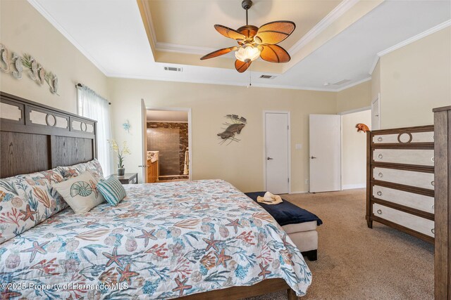 13027 Beacon Ct, Hudson, FL 34667 - carpeted bedroom with a raised ceiling, ornamental molding, ceiling fan, and ensuite bathroom