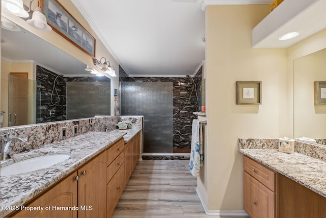 13027 Beacon Ct, Hudson, FL 34667 - bathroom featuring tiled shower, vanity, wood finished floors, and ornamental molding