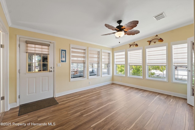 13027 Beacon Ct, Hudson, FL 34667 - unfurnished sunroom featuring ornamental molding and wood finished floors