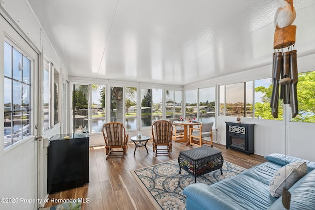 13027 Beacon Ct, Hudson, FL 34667 - sunroom with plenty of natural light, wood finished floors, and a water view