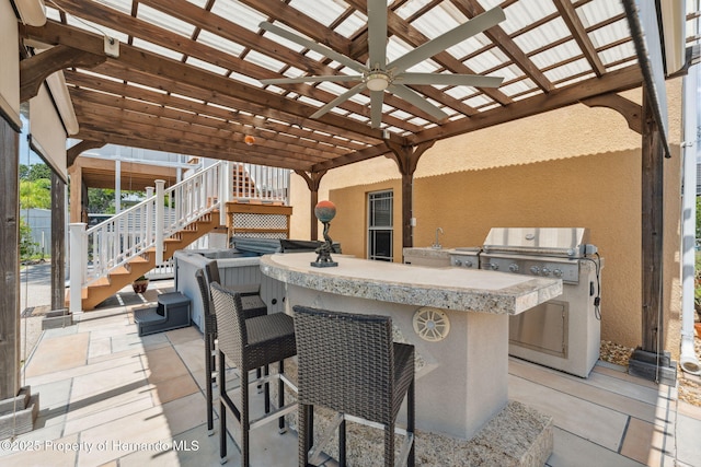 13027 Beacon Ct, Hudson, FL 34667 - view of patio / terrace featuring exterior kitchen, a ceiling fan, and stairway