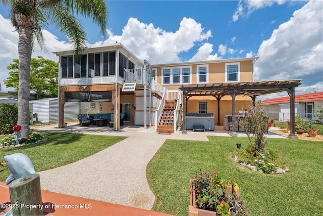 13027 Beacon Ct, Hudson, FL 34667 - rear view of property featuring a hot tub, a patio, a sunroom, a pergola, and outdoor lounge area