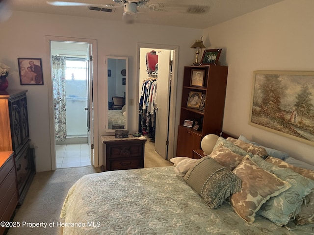 9474 Nakoma Way, Weeki Wachee, FL 34613 - bedroom featuring light carpet, a walk in closet, a closet, and ensuite bathroom