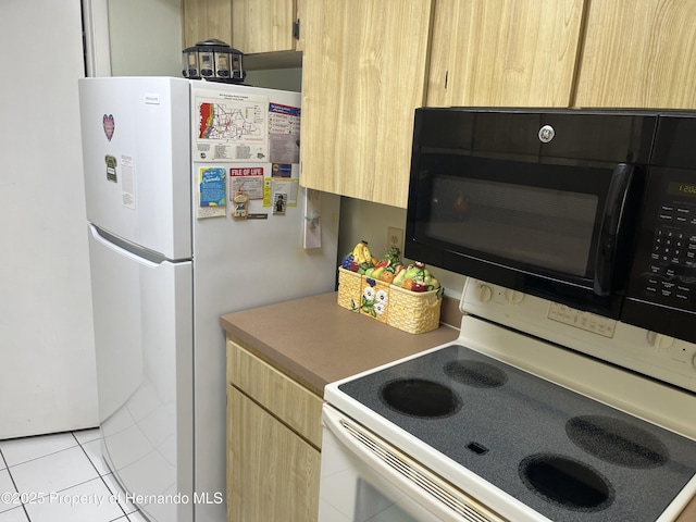 9474 Nakoma Way, Weeki Wachee, FL 34613 - kitchen featuring white appliances, light brown cabinets, and light tile patterned flooring