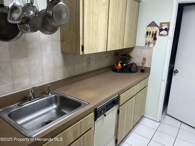 9474 Nakoma Way, Weeki Wachee, FL 34613 - kitchen with white dishwasher, tasteful backsplash, light tile patterned flooring, and light brown cabinetry