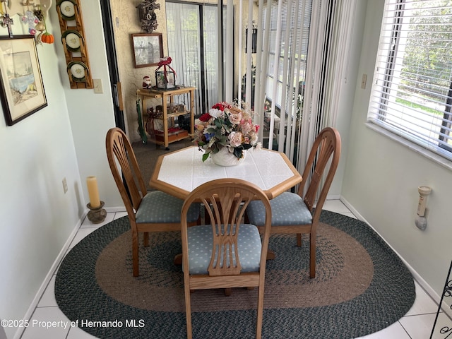 9474 Nakoma Way, Weeki Wachee, FL 34613 - tiled dining area featuring baseboards