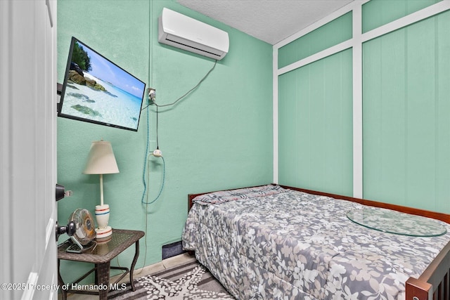 6241 Colony Cir, Weeki Wachee, FL 34607 - bedroom featuring a wall unit AC and a textured ceiling