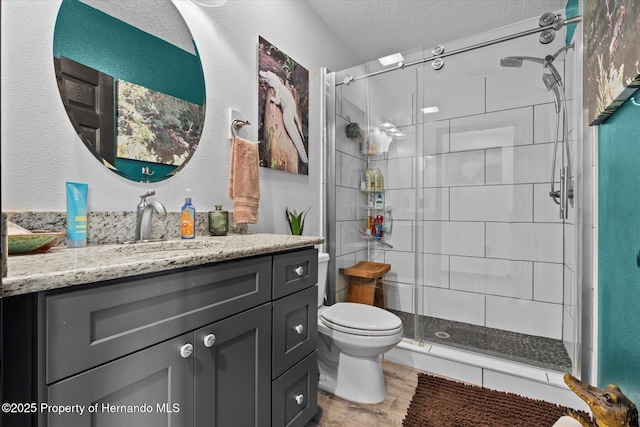 6241 Colony Cir, Weeki Wachee, FL 34607 - full bathroom with wood finished floors, a stall shower, vanity, and a textured ceiling