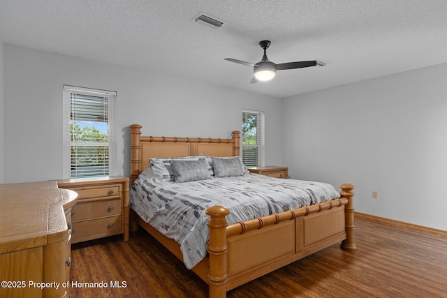 2295 Rio Cir, Spring Hill, FL 34608 - bedroom featuring wood finished floors, multiple windows, a textured ceiling, and ceiling fan