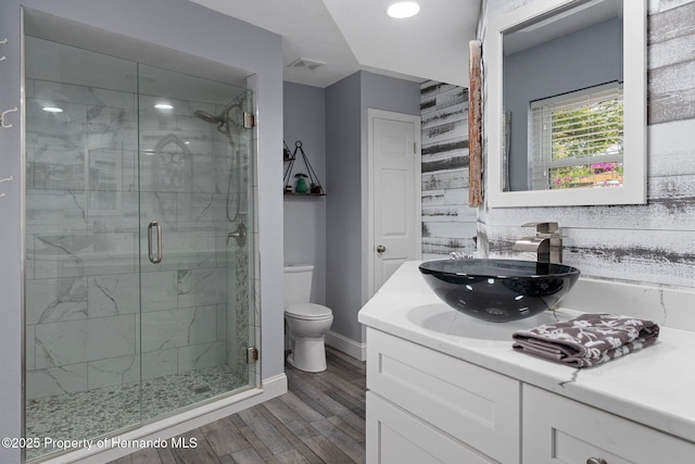 2295 Rio Cir, Spring Hill, FL 34608 - bathroom featuring vanity, a shower stall, wood finished floors, and recessed lighting