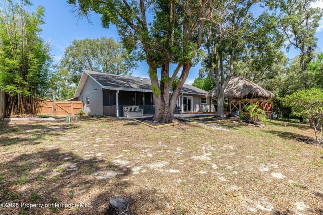 2295 Rio Cir, Spring Hill, FL 34608 - rear view of house featuring a sunroom and a gazebo