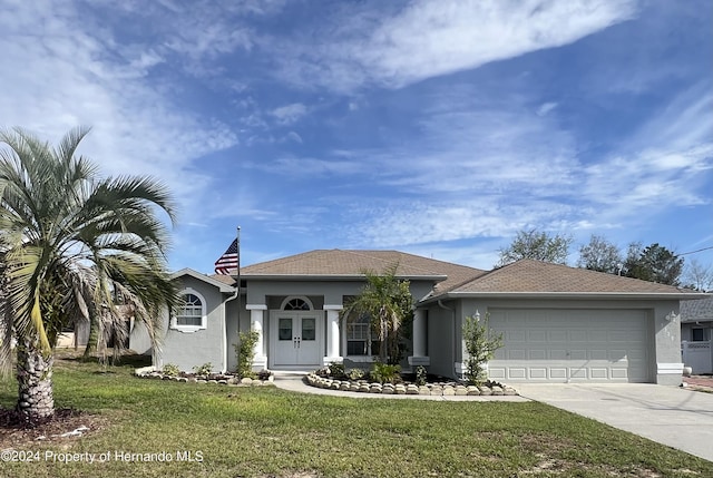 5388 Idleweise Ct, Spring Hill, FL 34606 - view of front of property with stucco siding, a garage, driveway, and a front yard