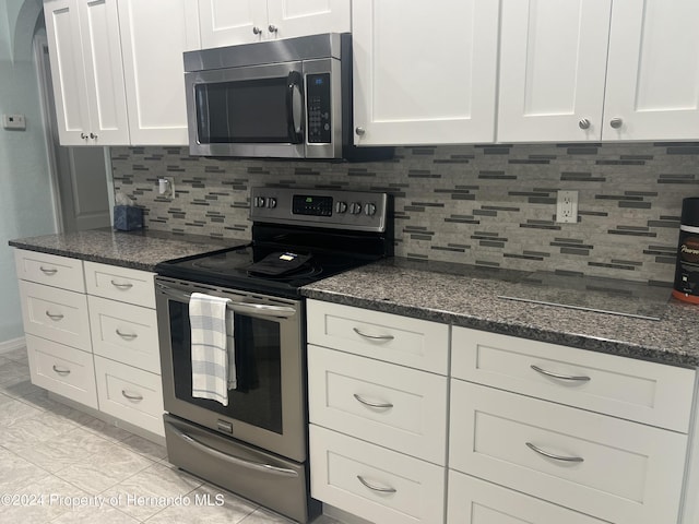 5388 Idleweise Ct, Spring Hill, FL 34606 - kitchen featuring stainless steel appliances, white cabinetry, and tasteful backsplash