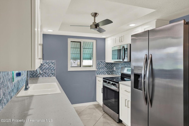 13332 Lisa Dr, Hudson, FL 34667 - kitchen with appliances with stainless steel finishes, ceiling fan, light countertops, white cabinets, and recessed lighting