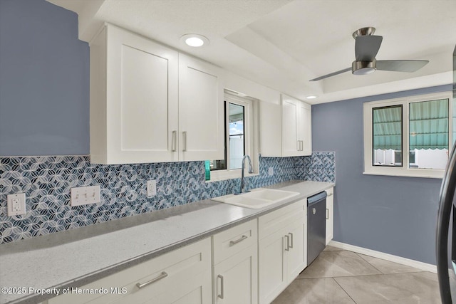 13332 Lisa Dr, Hudson, FL 34667 - kitchen with stainless steel dishwasher, decorative backsplash, light countertops, white cabinets, and recessed lighting