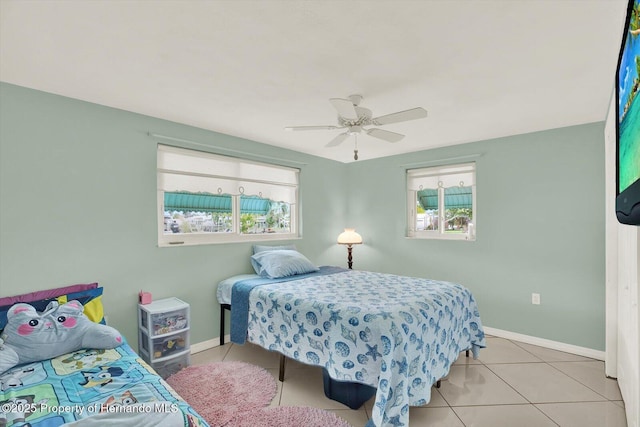 13332 Lisa Dr, Hudson, FL 34667 - tiled bedroom featuring multiple windows and a ceiling fan
