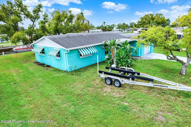 13332 Lisa Dr, Hudson, FL 34667 - view of front of home with a shingled roof and a front lawn