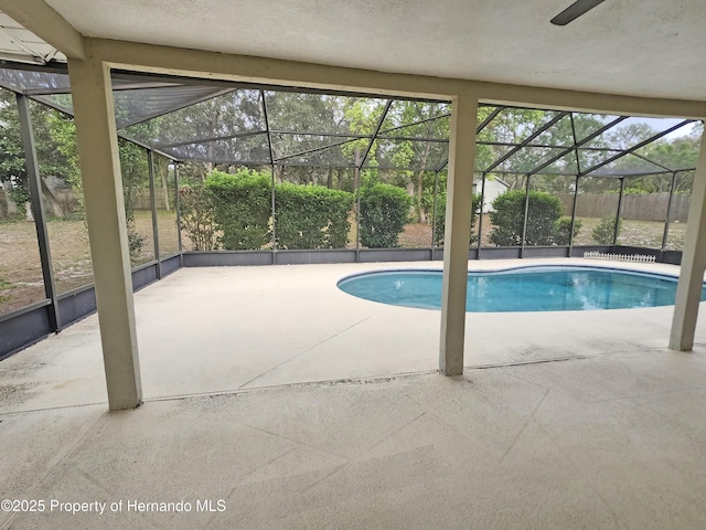 18232 Monteverde Dr, Spring Hill Pasco, FL 34610 - outdoor pool featuring a patio area, glass enclosure, and a fenced backyard