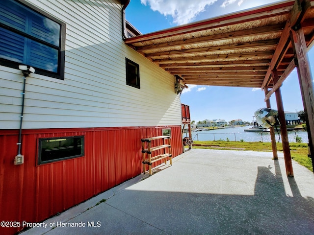 3179 Azalea Dr, Hernando Beach, FL 34607 - view of patio / terrace featuring a water view and a carport