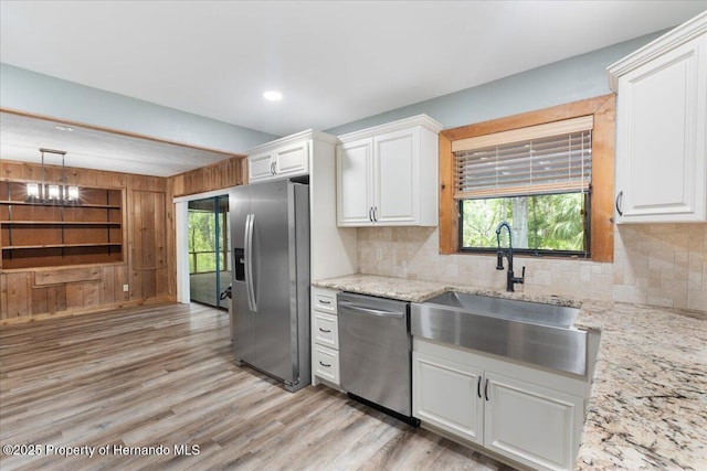 1518 Palm St, Steinhatchee, FL 32359 - kitchen featuring appliances with stainless steel finishes, white cabinetry, light wood-style flooring, tasteful backsplash, and recessed lighting