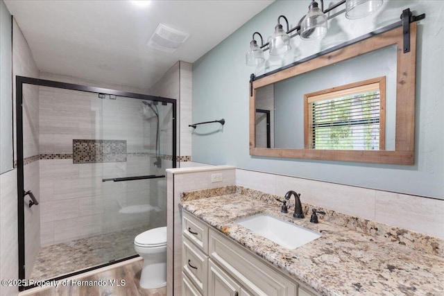 1518 Palm St, Steinhatchee, FL 32359 - full bathroom with vanity, a stall shower, and wood finished floors