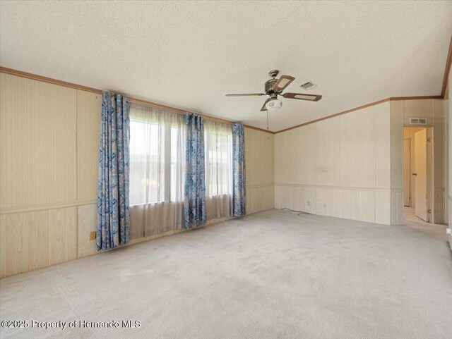 8017 Fiat Ave, Brooksville, FL 34613 - carpeted spare room featuring crown molding, a textured ceiling, and ceiling fan