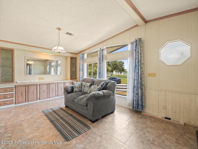 8017 Fiat Ave, Brooksville, FL 34613 - living room with crown molding, a textured ceiling, lofted ceiling, and wood walls
