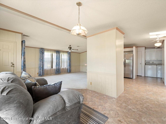 8017 Fiat Ave, Brooksville, FL 34613 - living room with a ceiling fan, washer and clothes dryer, ornamental molding, a textured ceiling, and light floors
