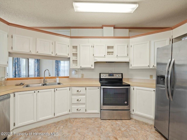 8017 Fiat Ave, Brooksville, FL 34613 - kitchen with stainless steel appliances, a textured ceiling, under cabinet range hood, light countertops, and white cabinetry