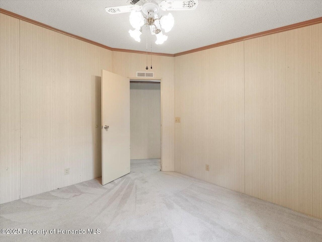 8017 Fiat Ave, Brooksville, FL 34613 - carpeted spare room featuring a ceiling fan, ornamental molding, and a textured ceiling