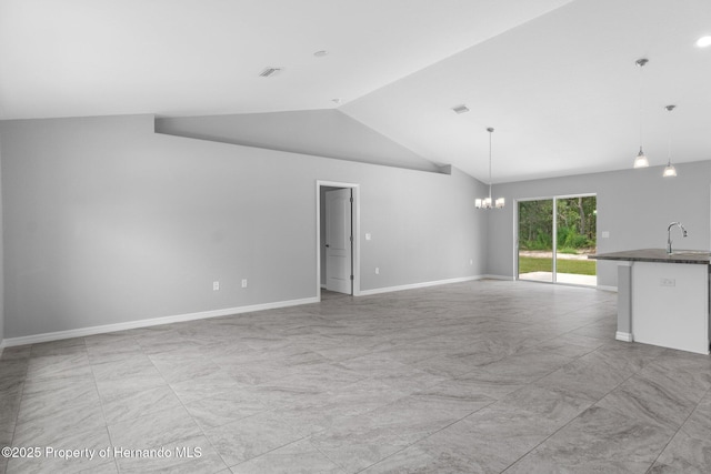 12128 Petrel Ave, Brooksville, FL 34614 - unfurnished living room featuring a chandelier and lofted ceiling