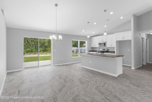 12128 Petrel Ave, Brooksville, FL 34614 - kitchen featuring appliances with stainless steel finishes, white cabinetry, a chandelier, an island with sink, and recessed lighting