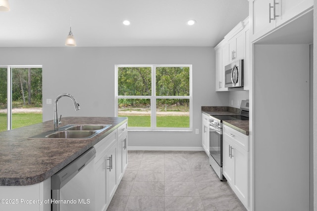 12128 Petrel Ave, Brooksville, FL 34614 - kitchen with appliances with stainless steel finishes, dark countertops, plenty of natural light, and recessed lighting