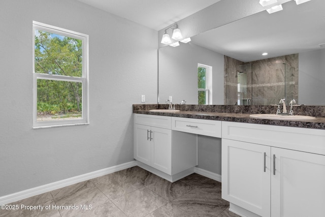 12128 Petrel Ave, Brooksville, FL 34614 - bathroom featuring double vanity and a stall shower