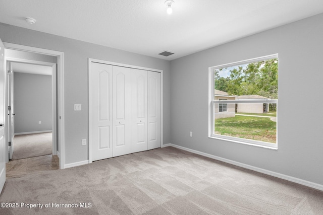 12128 Petrel Ave, Brooksville, FL 34614 - unfurnished bedroom featuring carpet flooring and a closet
