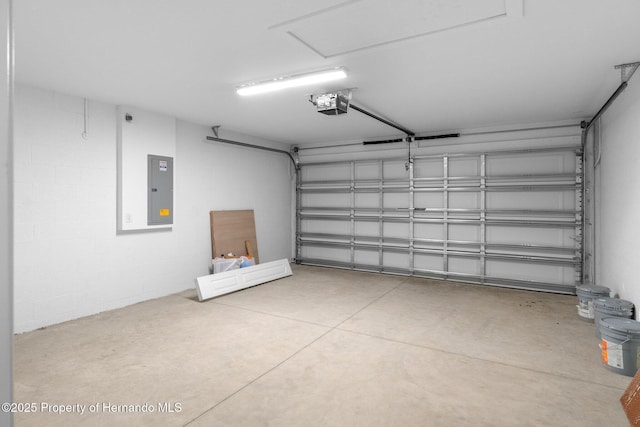 12128 Petrel Ave, Brooksville, FL 34614 - garage with electric panel and a garage door opener