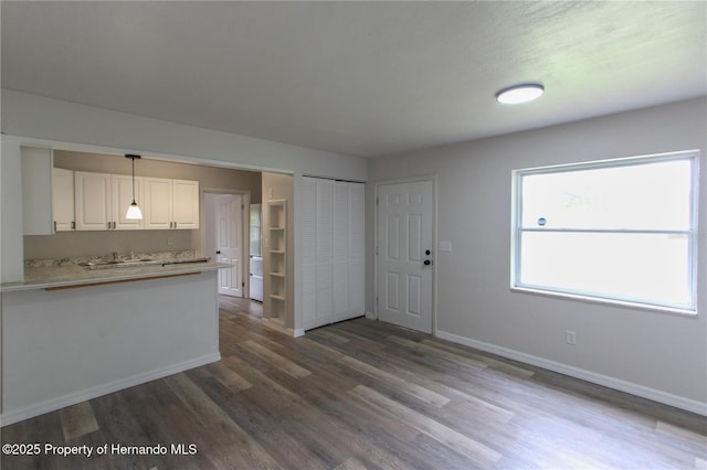9345 N Elliot Way, Citrus Springs, FL 34434 - kitchen with white cabinets, dark wood-style flooring, light countertops, decorative light fixtures, and a peninsula
