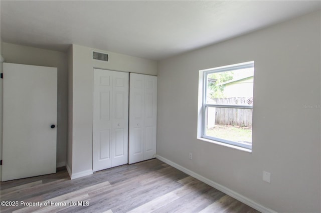 9345 N Elliot Way, Citrus Springs, FL 34434 - unfurnished bedroom featuring a closet and light wood-type flooring