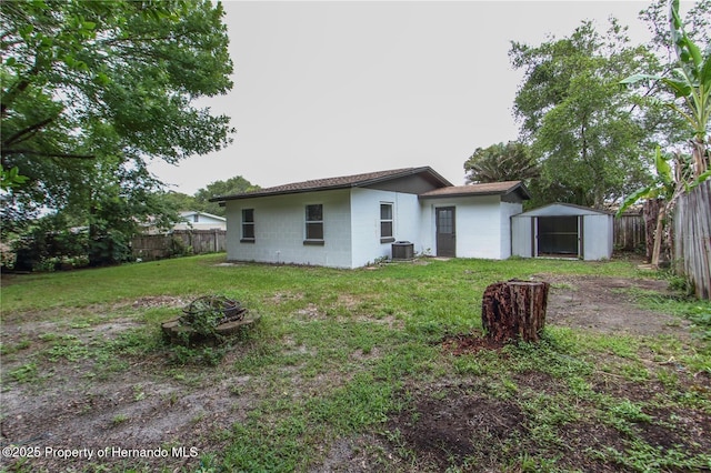 9345 N Elliot Way, Citrus Springs, FL 34434 - rear view of property featuring a storage unit, a fenced backyard, a fire pit, and concrete block siding