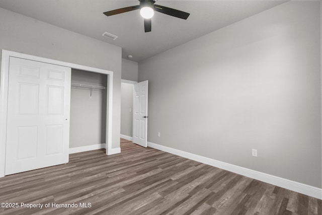 16113 Penn State Rd, Weeki Wachee, FL 34614 - unfurnished bedroom with wood finished floors, a closet, and ceiling fan