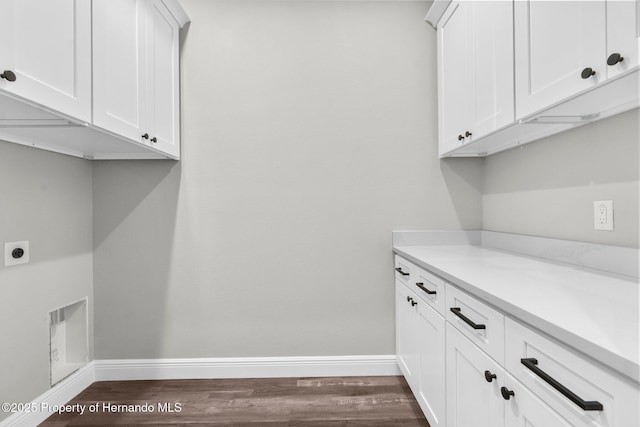 16113 Penn State Rd, Weeki Wachee, FL 34614 - washroom with dark wood-type flooring, hookup for an electric dryer, and cabinet space