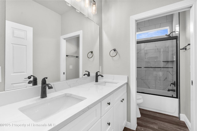16113 Penn State Rd, Weeki Wachee, FL 34614 - bathroom featuring double vanity, wood finished floors, and shower / bath combination