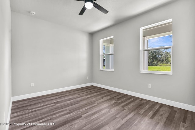 16113 Penn State Rd, Weeki Wachee, FL 34614 - spare room with dark wood finished floors, ceiling fan, and a smoke detector